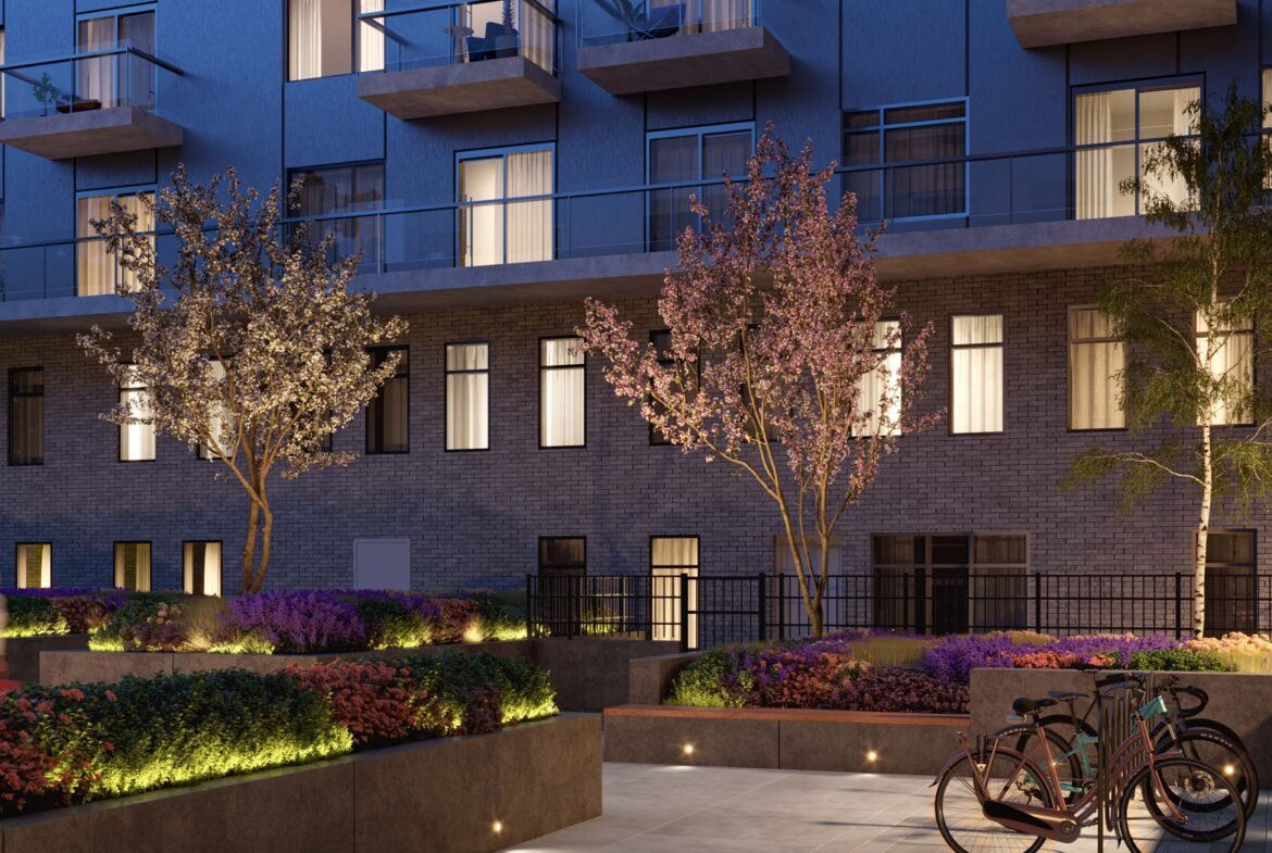An apartment building with bicycles parked in front of it, showcasing new condos in Gta.