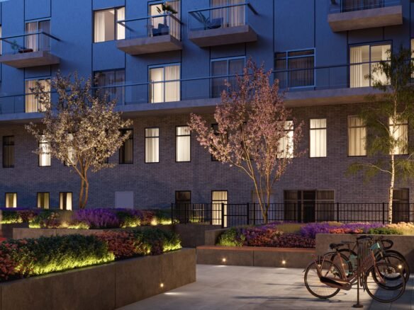 An apartment building with bicycles parked in front of it, showcasing new condos in Gta.