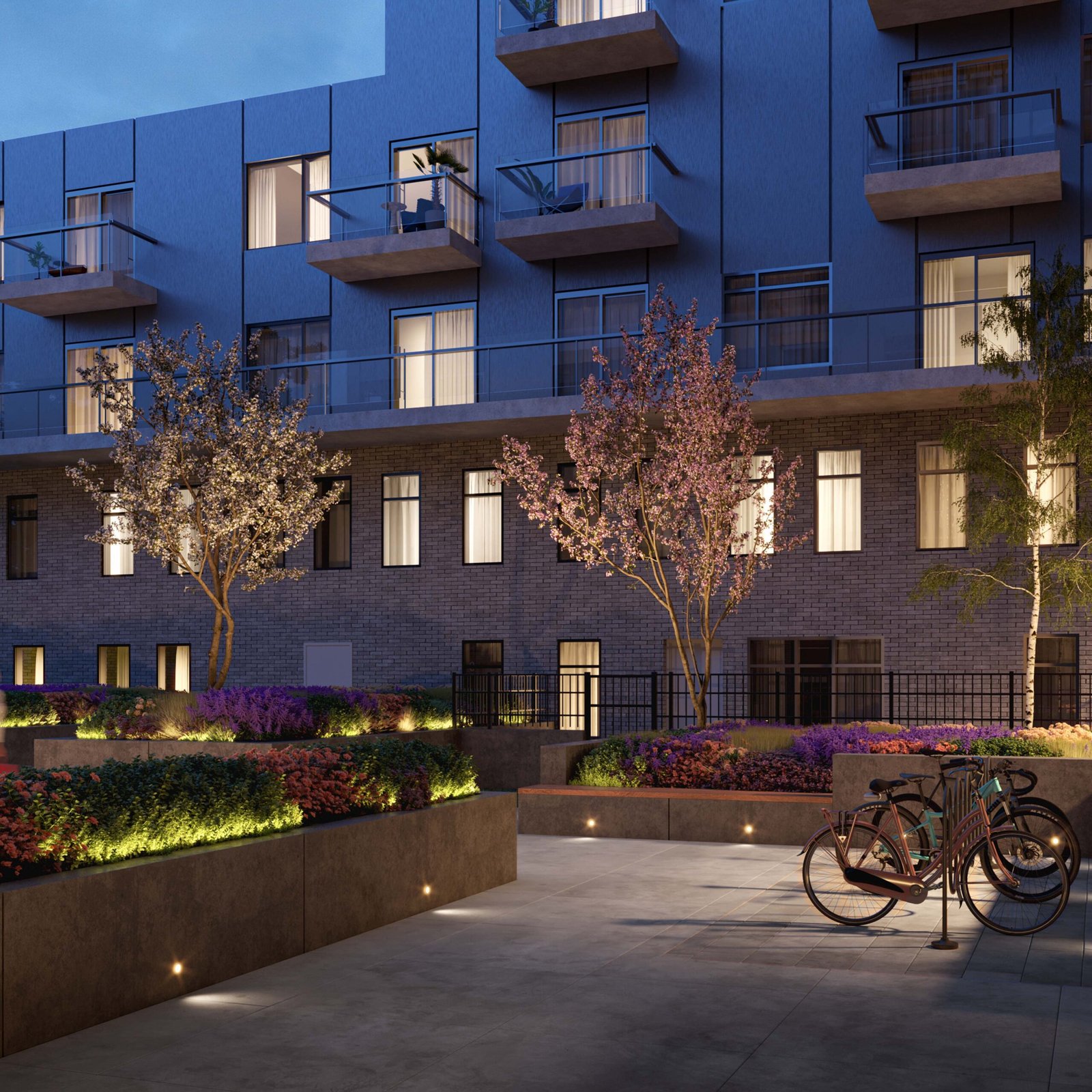 An apartment building with bicycles parked in front of it, showcasing new condos in Gta. An apartment building with bicycles parked in front of it, showcasing new condos in Gta.