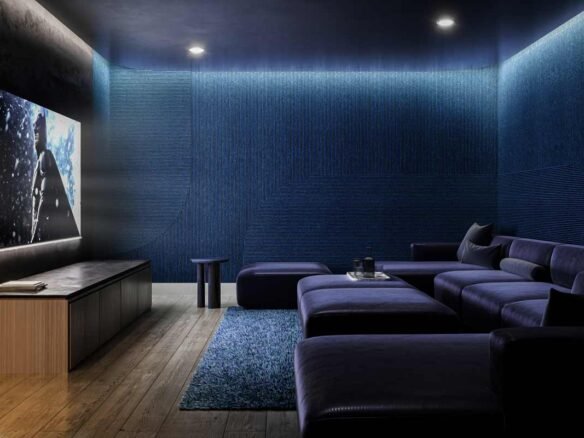 A home theater room with blue walls and a TV. New homes in Gta, Pre construction Homes, New condos in Gta.