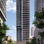 A contemporary high-rise with a distinctive zigzag pattern of balconies stands against a clear blue sky in Brampton. Lined with trees, the street below features a historic brick building and a few pedestrians, offering an inviting contrast to the new condos that redefine modern living.