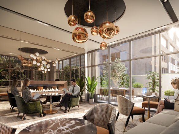 A modern lounge area in new homes showcases people seated around a fireplace, surrounded by green plants. The room features large windows, brown and beige seating, and contemporary copper pendant lights hanging from the ceiling, creating an inviting atmosphere.