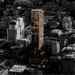 Aerial view of a cityscape at dusk with a prominent golden skyscraper casting long shadows among surrounding buildings. The reflective surface contrasts with the darker tones of the city, while new condos in Brampton rise up on the horizon, enhancing the modern skyline.
