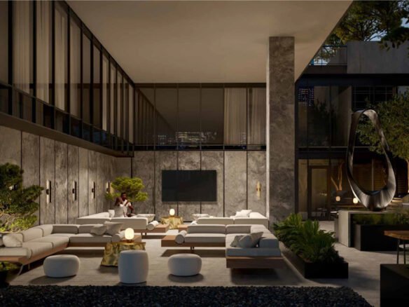 An elegant living room in a new home showcases plush seating, a large TV, and ambient lighting. The space accentuates greenery, marble walls, and floor-to-ceiling windows. With someone seated on the couch, this stylish interior offers a cozy and lived-in ambiance.