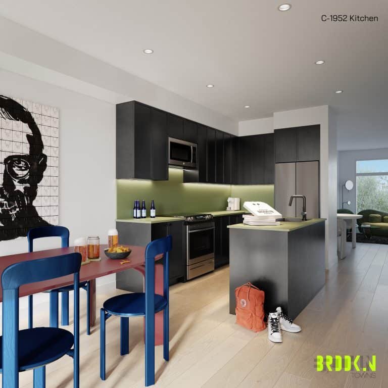 Modern kitchen with dark cabinetry and a green backsplash at Brooklin Towns. An island with a sink is in the center, accompanied by a stylish table with blue and red chairs. A red backpack is on the floor, and a pop art painting hangs on the wall. The text "C-1952 Kitchen" is in the top right corner.