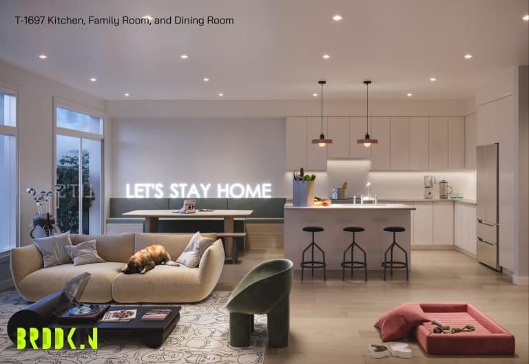 A modern, cozy living space at Brooklin Towns featuring a kitchen, family room, and dining area. A tan sectional sofa with a dog resting on it faces a coffee table and a neon "LET'S STAY HOME" sign. The kitchen has sleek white cabinets, pendant lights, and a breakfast bar with stools. A pet bed and toys are on the floor.