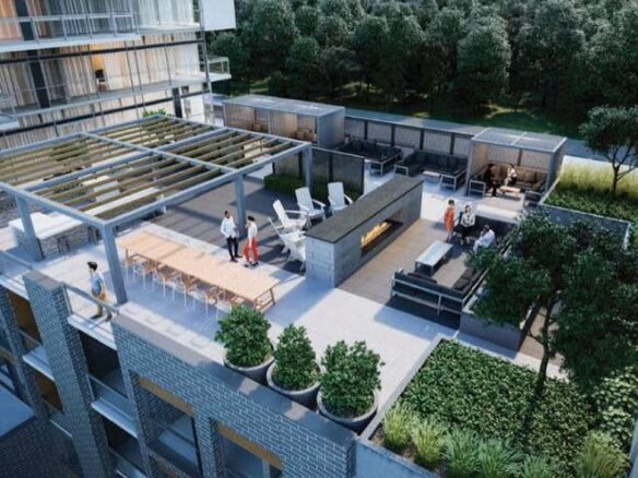 A modern rooftop terrace with a mix of seating areas, including lounge chairs, tables, and a central fireplace graces the view from new homes in GTA. The terrace is surrounded by plants and trees, with a pergola providing partial shade. A few people are seen enjoying the space.