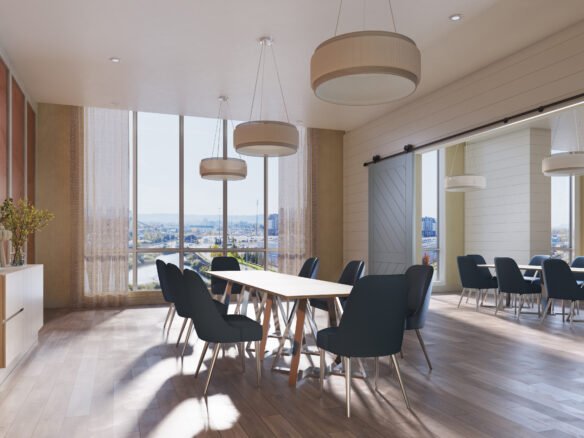 A modern conference room with large windows allowing natural light to fill the space. The room features a long wooden table surrounded by dark blue chairs. Three large, round pendant lights hang from the ceiling. Ideal for meetings about new condos in GTA, the room has light wood flooring and minimalistic decor.