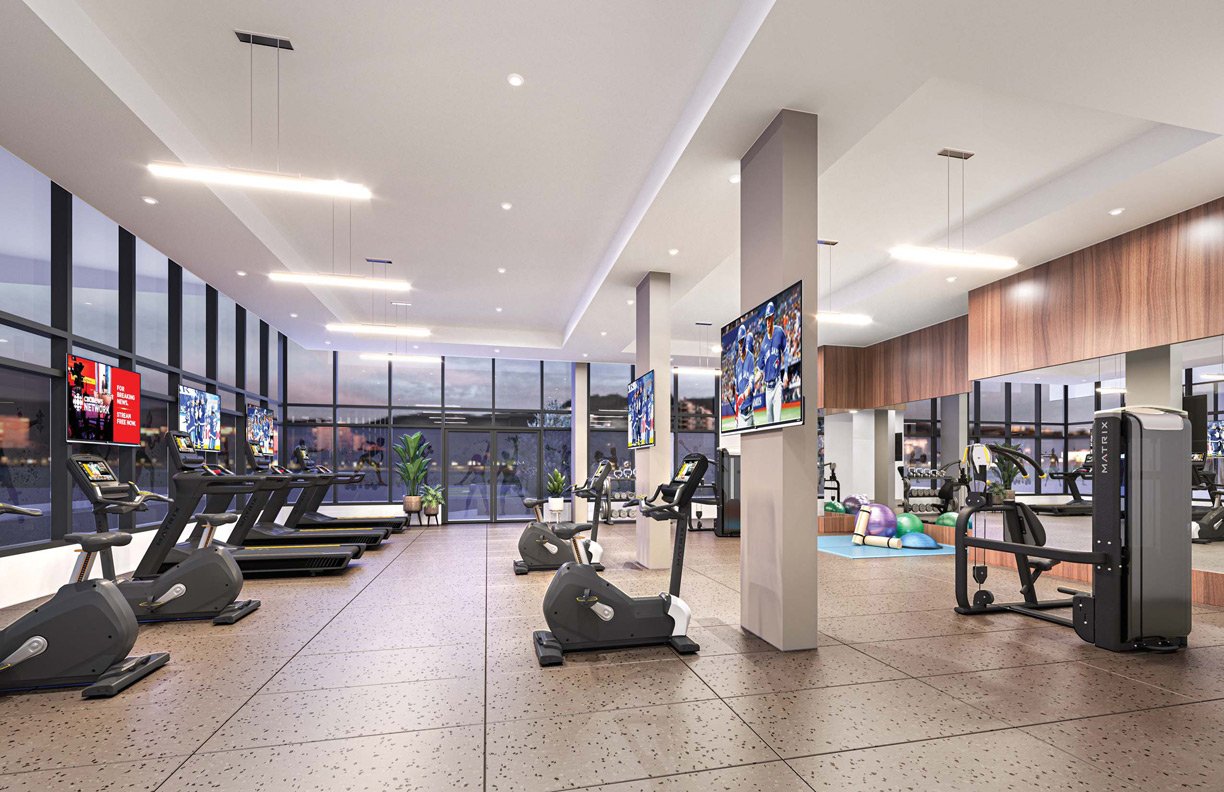 Interior of a modern gym featuring treadmills, exercise bikes, weight machines, and fitness balls. TVs mounted on walls and large windows in a well-lit space. Interior of a modern gym featuring treadmills, exercise bikes, weight machines, and fitness balls. TVs mounted on walls and large windows in a well-lit space.