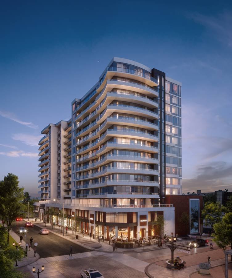 A modern, multi-story apartment building with numerous glass balconies is illuminated at dusk. The building has a sleek design with curved edges and ground-floor businesses. Surrounding it are well-lit streets, cars, trees, and pedestrians, showcasing the allure of new condos in GTA.
