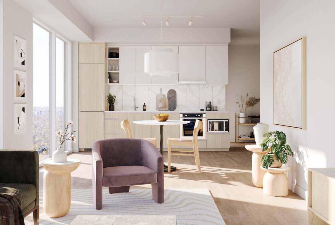 A modern kitchen in new condos with beige cabinets and a white marble backsplash. The open space features a round dining table, purple and green armchairs, and large windows with urban views. Bright