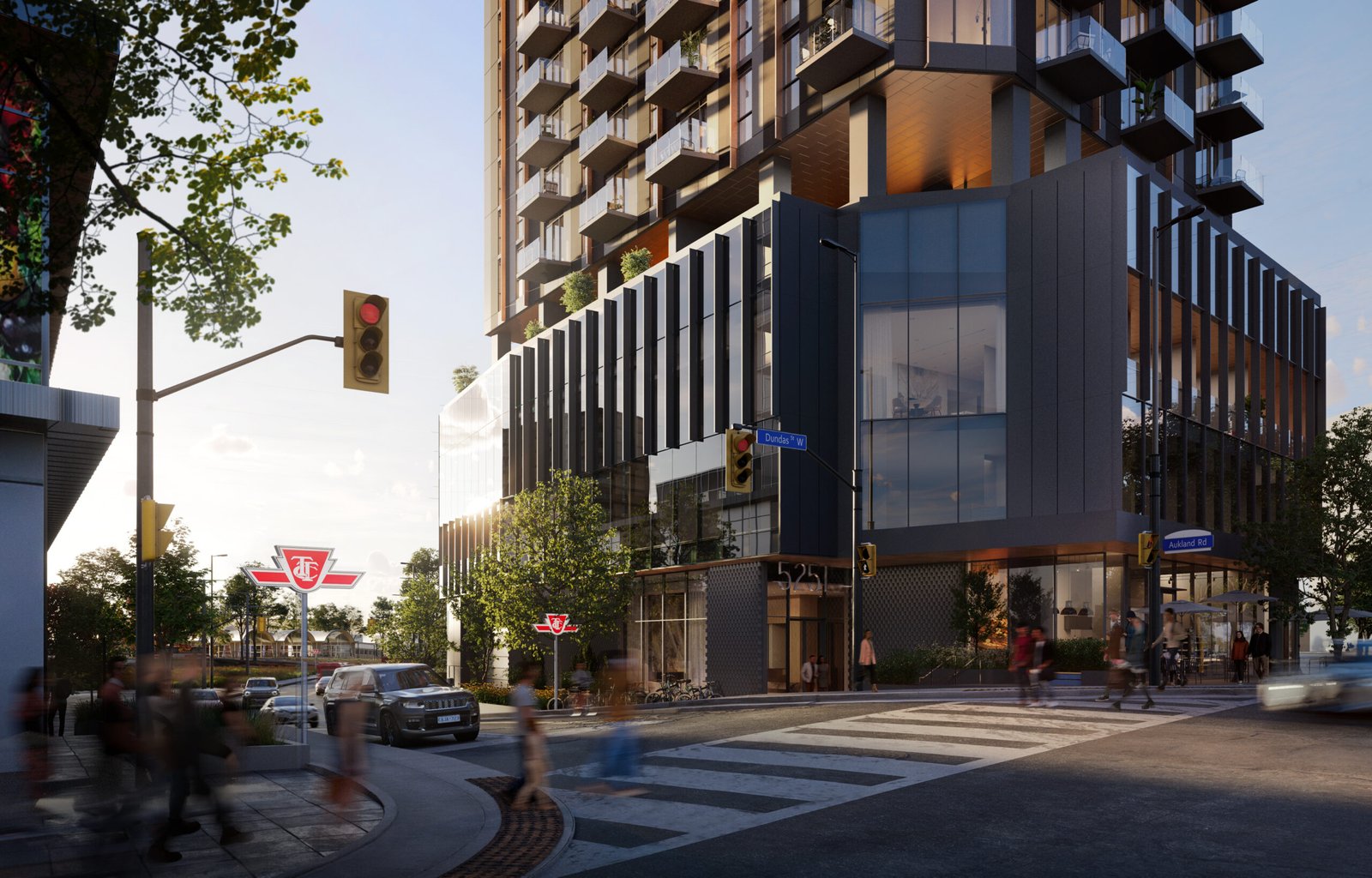 A vibrant street scene at dusk featuring a modern multi-story building with illuminated windows, pedestrians crossing the street, and blurred motion of cars. Trees line the sidewalk where signs for New Condos are visible.
