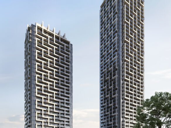 Two tall buildings with trees and grass.