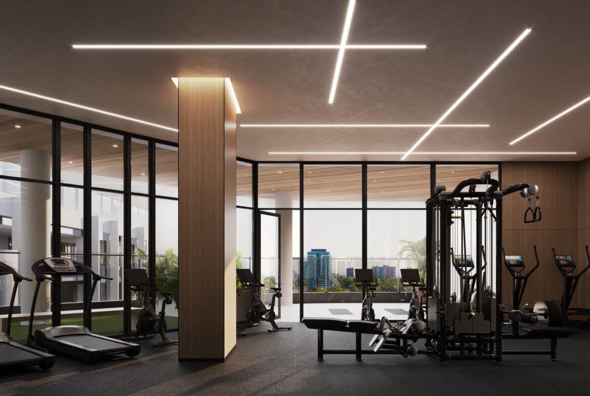 A gym room in a pre-construction building with a view of the city.
