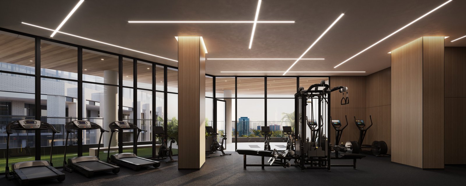 A gym room in a pre-construction building with a view of the city.