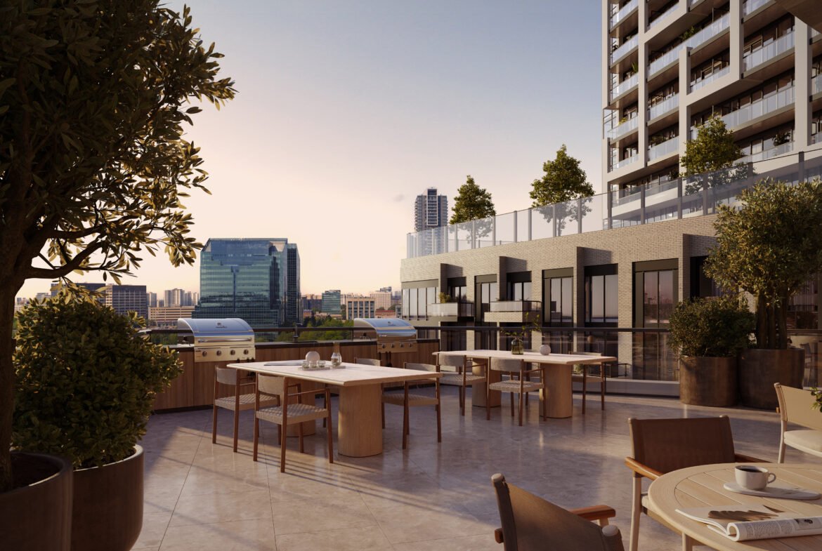 An outdoor rooftop dining area of a modern building, featuring several tables set for dining, potted plants, and overlooking a cityscape during sunset. Browse our Sg Homes for similar views in