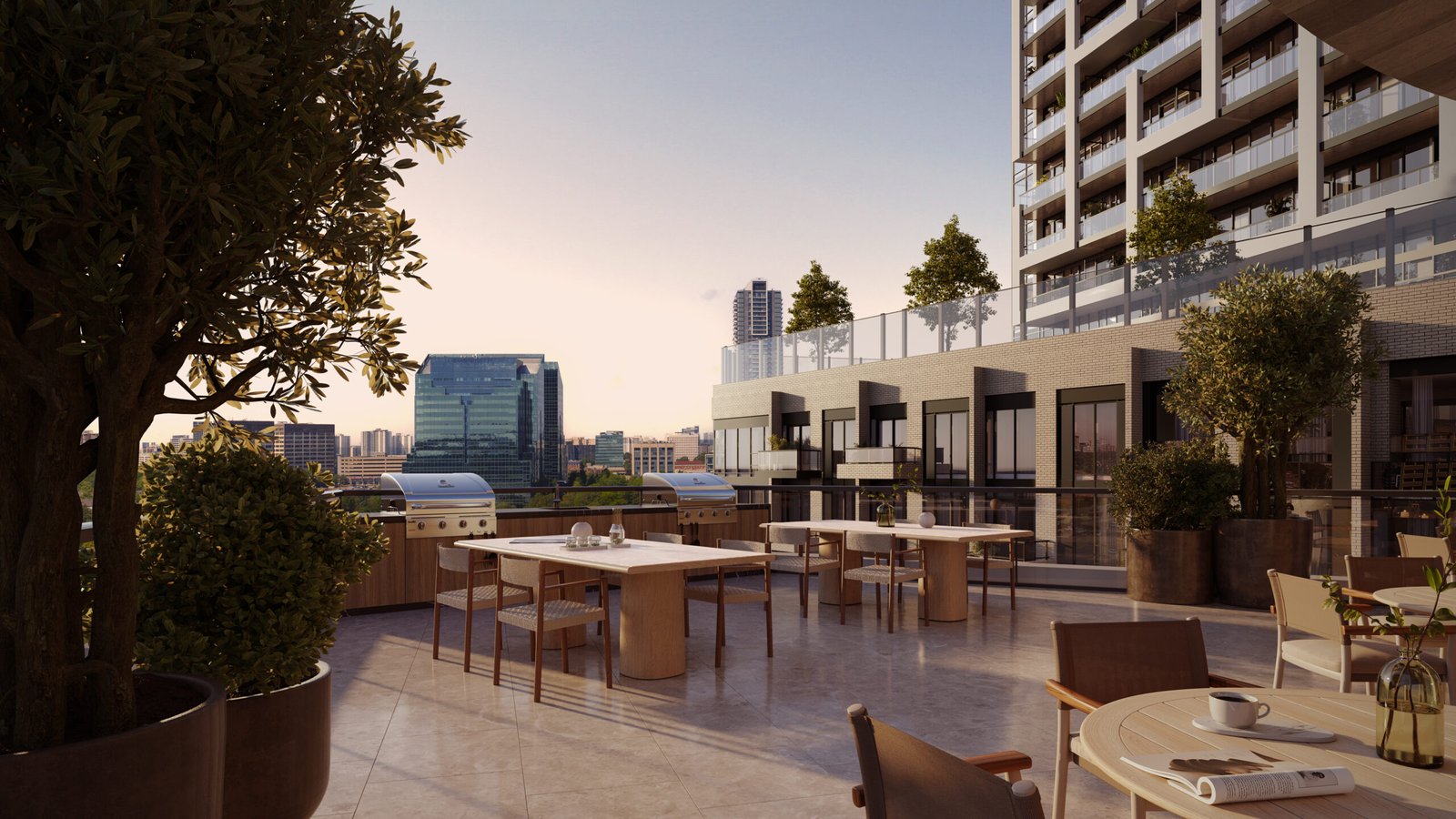 An outdoor rooftop dining area of a modern building, featuring several tables set for dining, potted plants, and overlooking a cityscape during sunset. Browse our Sg Homes for similar views in