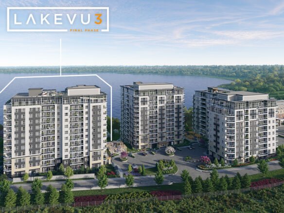 Aerial view of three modern high-rise buildings labeled "Lakevu3 Final Phase" near a lake. These new condos in Brampton are surrounded by lush greenery and a road, with the lake and trees creating a tranquil backdrop under a partly cloudy sky.