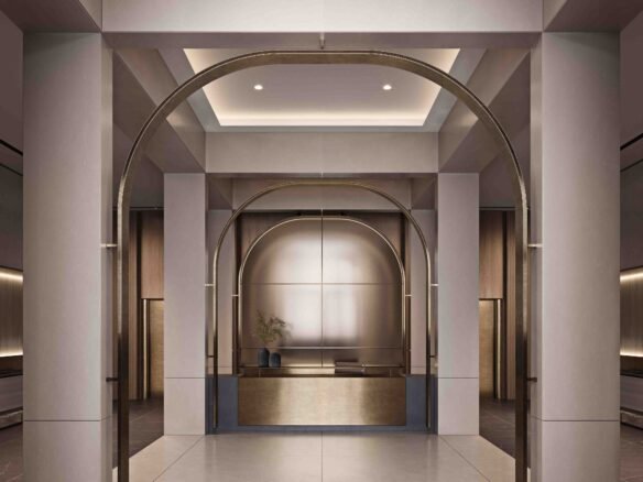 An artist's concept of pre-construction homes featuring a modern lobby with elegant archways, warm lighting, and a minimalist reception desk centered against a backdrop of potted plants and a decorative wall panel.