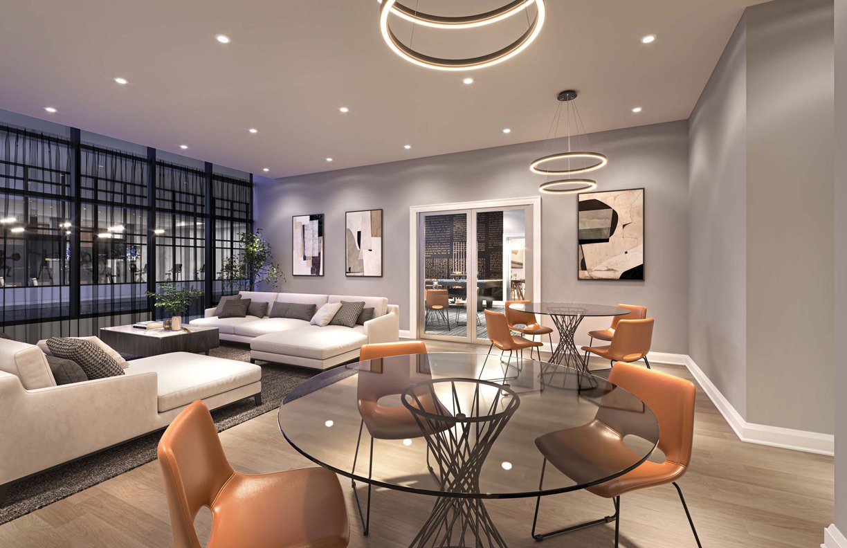A modern apartment living area with a lounge section featuring a gray sofa, a dining area with a round glass table and orange chairs, and stylish circular ceiling lights. Large windows provide a city view. A modern apartment living area with a lounge section featuring a gray sofa, a dining area with a round glass table and orange chairs, and stylish circular ceiling lights. Large windows provide a city view.