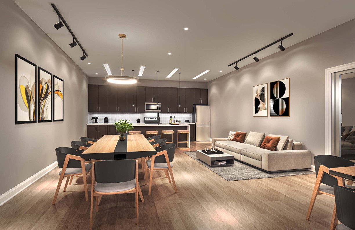 Modern open-plan living space featuring a kitchen with dark cabinetry, a dining area with a large wooden table, and a lounge with beige sofa, all under warm ambient lighting in New Condos Modern open-plan living space featuring a kitchen with dark cabinetry, a dining area with a large wooden table, and a lounge with beige sofa, all under warm ambient lighting in New Condos
