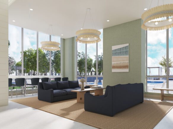 A modern lounge area in one of the stunning new homes in GTA features large windows revealing a pool outside. Inside, two dark blue sofas sit on a beige rug with a wooden coffee table between them, and three contemporary chandeliers hang from the ceiling. Bar stools line a counter near the windows.
