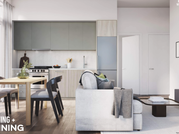 Modern living and dining area with an open-concept design in new homes. A wooden dining table with black chairs is situated near the compact kitchen, which features sleek cabinets and stainless steel appliances. A light gray sofa faces a wall-mounted TV. Contemporary decor adorns the space.