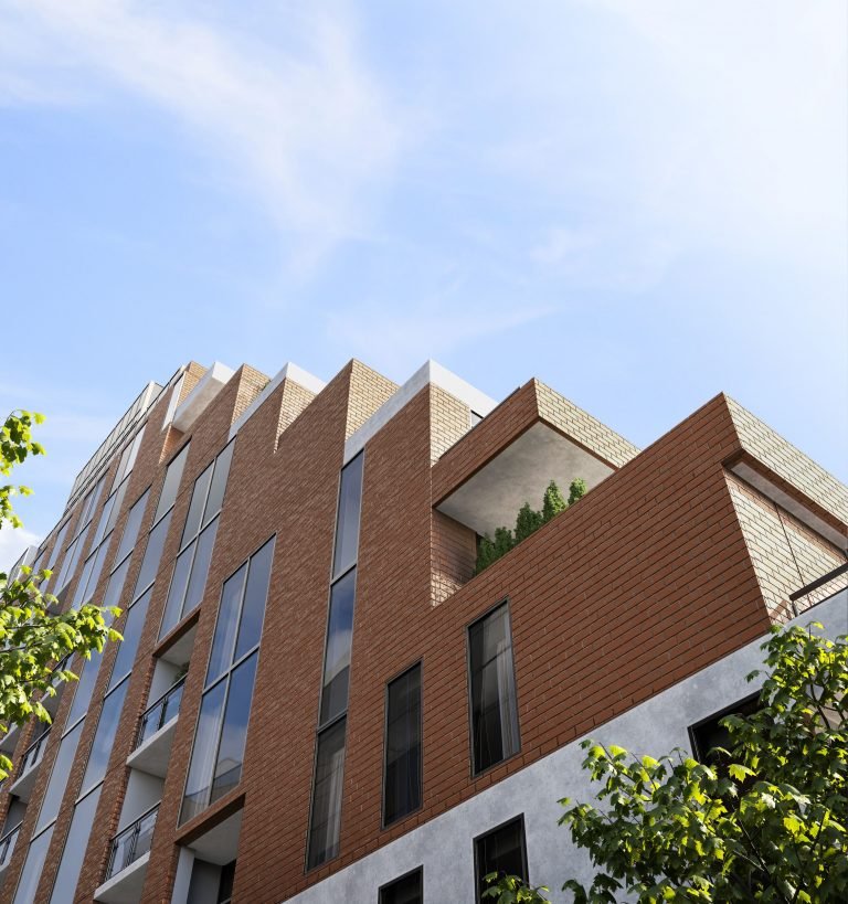 The Six99 Condos is a modern multi-story brick apartment building with large windows under a clear blue sky. The structure features sharp, angular designs with a corner balcony adorned with greenery. Trees partly frame the view, adding a natural element to the urban scene. The Six99 Condos is a modern multi-story brick apartment building with large windows under a clear blue sky. The structure features sharp, angular designs with a corner balcony adorned with greenery. Trees partly frame the view, adding a natural element to the urban scene.
