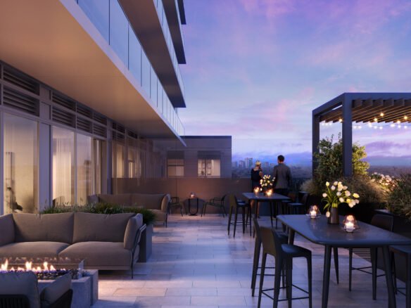 A modern outdoor rooftop terrace at dusk with stylish furniture, a fire pit, and illuminated tables. Two people admire the distant cityscape under a twilight sky, near new homes in GTA.