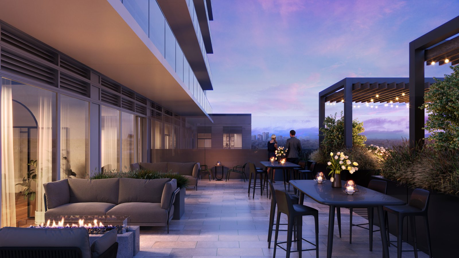 A modern outdoor rooftop terrace at dusk with stylish furniture, a fire pit, and illuminated tables. Two people admire the distant cityscape under a twilight sky, near new homes in GTA.