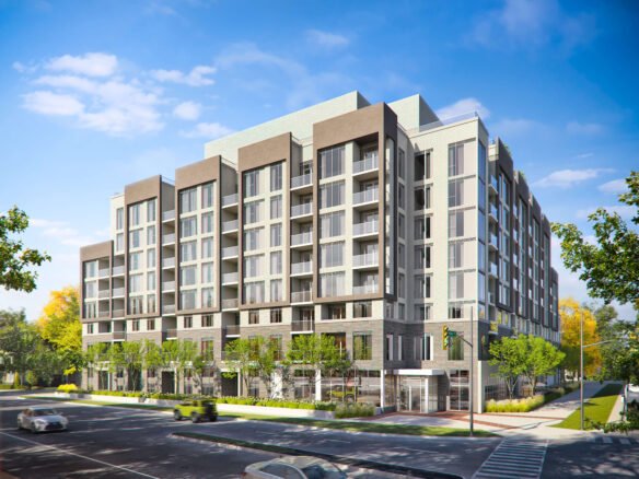 Discover modern multi-story apartments with a light-colored facade, balconies, and large windows. These stunning new condos in Brampton are nestled among trees at a street corner with crosswalks. Enjoy clear blue skies as part of the charming neighborhood landscape.