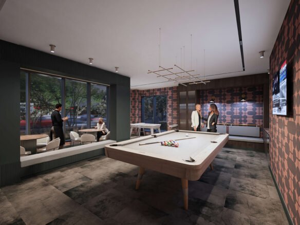 A modern game room in new homes showcases two people by a pool table and two others seated by a window. The room, perfect for pre-construction homes, is decorated with patterned walls, a TV, and a unique ceiling light fixture.