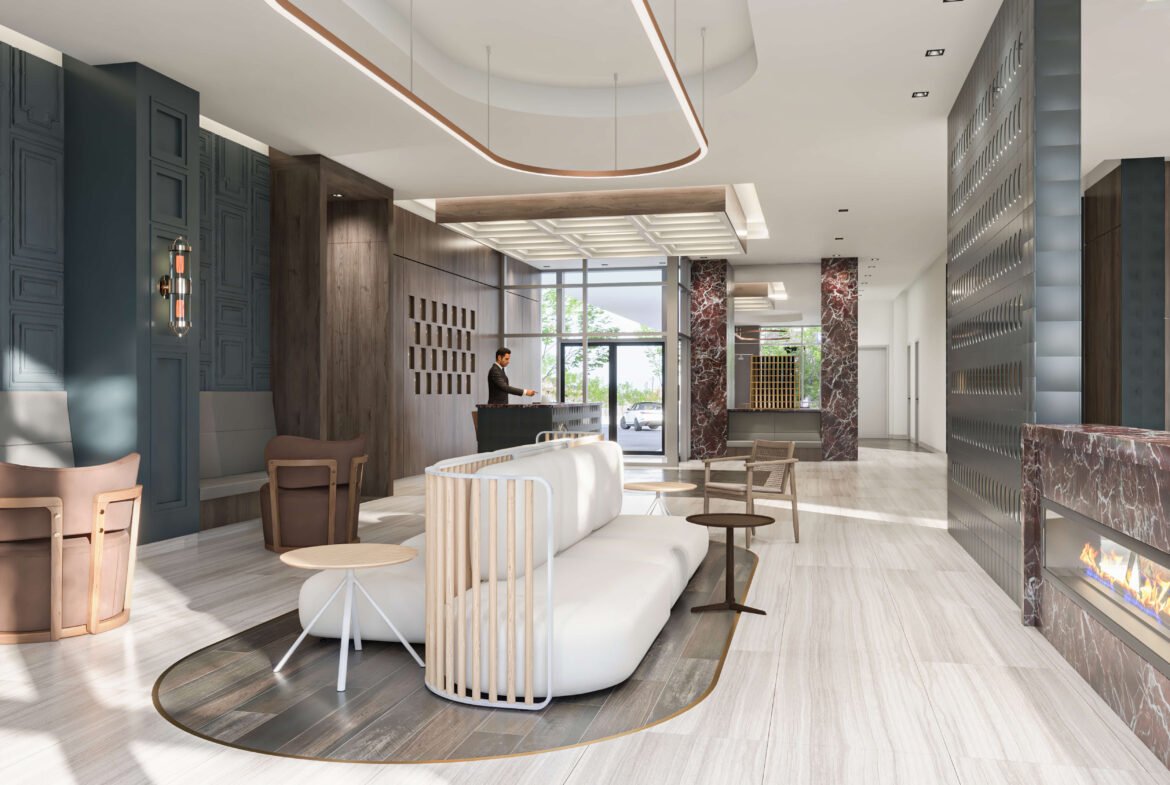 The modern hotel lobby boasts a sleek design with a white curved sofa and wooden chairs on a circular rug. To the right, a recessed fireplace adds warmth. The large window floods the space with light, complementing the reception desk in the background. Ideal inspiration for new condos in Brampton decor enthusiasts.
