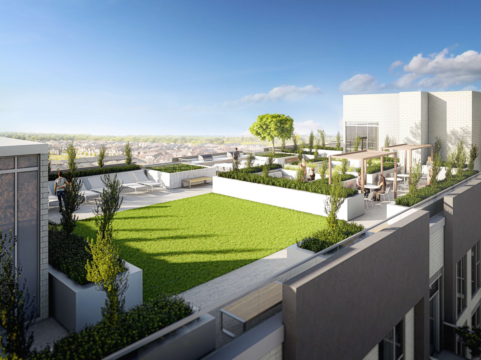 A rooftop terrace with modern design showcases a green lawn, white planters, and seating areas enveloped by lush greenery. A few people relish the sunny day under clear skies, enjoying a panoramic city view. This serene space is part of pre-construction homes offering luxury and tranquility.