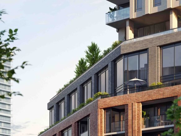 New condos in a modern residential building with brick, glass, and metal finishes featuring balconies with greenery, set against a backdrop of lush trees.