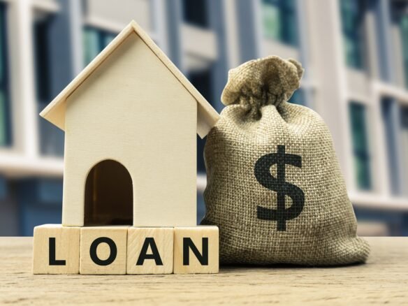 Home loan, mortgage, home insurance, financial mortgage for house concept. A dollar money in bag and residential model on a wooden block. Depicts borrow sum of money or savings for item of a property.