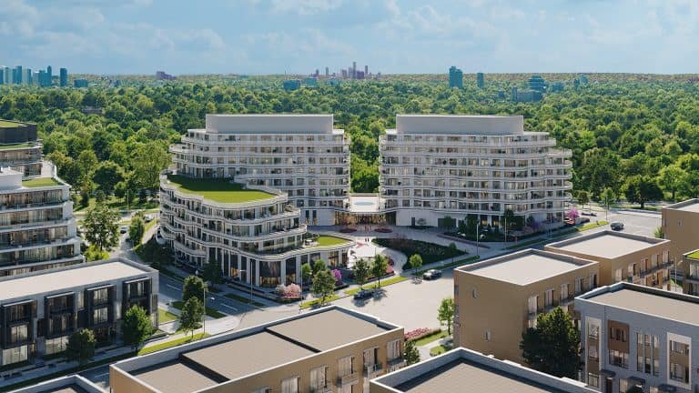 Aerial view of modern Sg Homes with lush green roofs, situated next to a dense tree park, with a distant city skyline under a clear blue sky.
