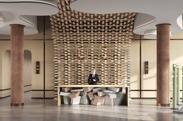 Modern hotel lobby with a unique wooden reception desk, artistic columns, and a male receptionist standing ready to assist guests. Large windows provide ample natural light, ideal for showcasing new homes in GTA.