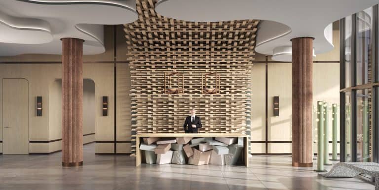 Modern hotel lobby with a unique wooden reception desk, artistic columns, and a male receptionist standing ready to assist guests. Large windows provide ample natural light, ideal for showcasing new homes in GTA.