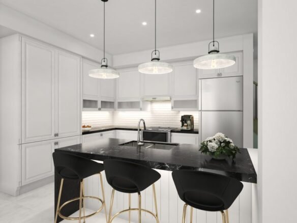 A modern kitchen in a pre-construction home features white cabinets, a black marble island, and three pendant lights. The island boasts three black stools with gold accents. A stainless steel fridge and a potted plant complete the elegant space.