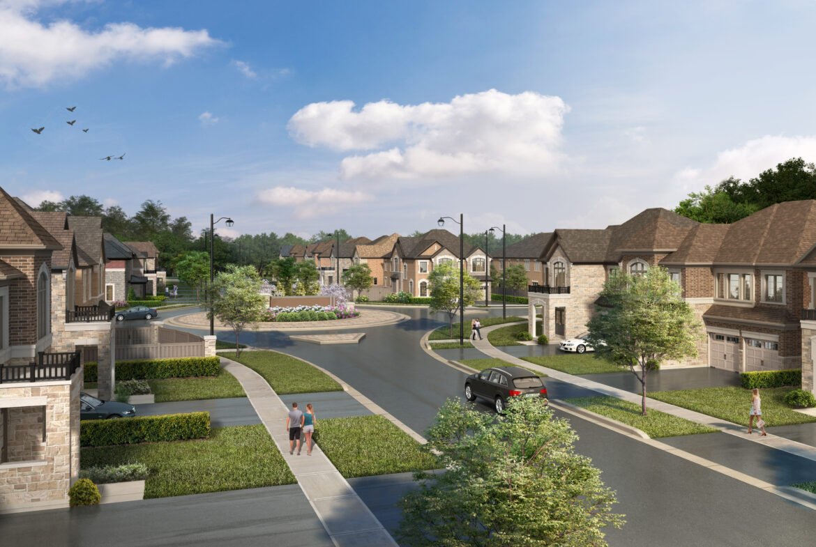 A suburban neighborhood with modern two-story houses, curved streets, and manicured lawns. A few people and a car are on the street. Trees and a roundabout with a garden enhance the scenic atmosphere under a blue sky with clouds, ideal for those seeking new homes in Brampton.