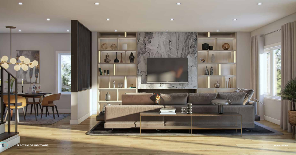 A modern living room with a large brown sectional sofa faces a wall-mounted TV. The wall showcases built-in shelves with decorative items. Bathed in natural light from windows and recessed ceiling lights, it exudes warmth. A dining area is visible to the left, ideal for those considering new condos in GTA.
