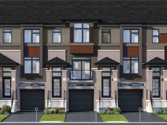 A row of new homes with dark roofs, large windows, and varied paneling in neutral shades. Each unit features a black garage door and a small landscaped front yard with grass and flowers. Trees provide a lush backdrop, enhancing the appeal of this modern community.