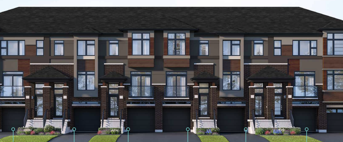 A row of modern townhouses with brown and beige exteriors features large windows and individual driveways. These pre-construction homes boast dark roofs accented with brickwork. Small grass patches adorn the front of each unit, while trees are visible on the right.