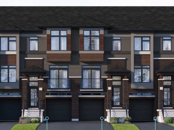 A row of modern townhouses with brown and beige exteriors features large windows and individual driveways. These pre-construction homes boast dark roofs accented with brickwork. Small grass patches adorn the front of each unit, while trees are visible on the right.
