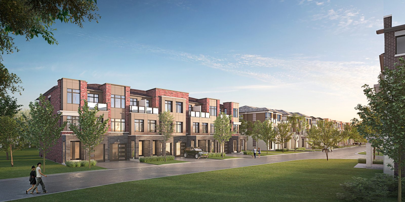 A row of modern, red-brick townhouses lines a tree-lined street. The new homes feature large windows and balconies. Two people walk along the sidewalk, and a car is parked in a driveway. The sky is clear and blue, suggesting it's a sunny day.
