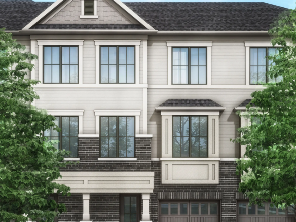 Discover a modern three-story townhouse with gray siding and dark brick accents, large windows, and two garage doors. Flanked by trees against a clear blue sky, it exemplifies the charm of new homes in Brampton.