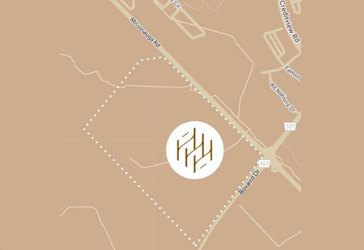 A map highlights a section of Mississippi Road, intersecting with Road 107 and 431 Manas Drive. A dotted boundary encircles an area, showcasing pre-construction homes. At the center, a circular logo with stylized lines lies on a brown background.