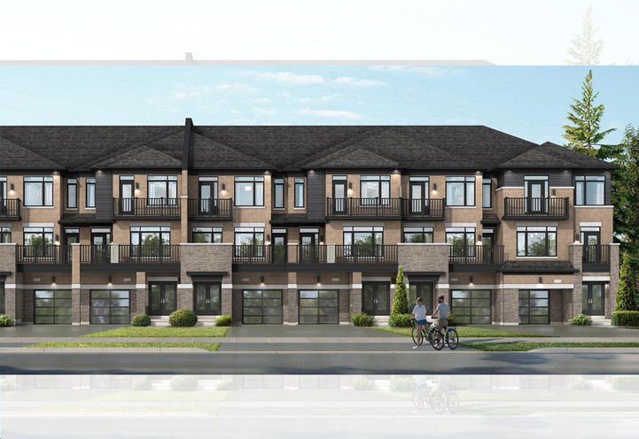 A modern townhouse complex with stylish two-story buildings features dark roofs and numerous balconies. The facade blends brick and glass elements. Two people ride bicycles on the pavement in front, while trees and a clear sky grace the background, highlighting the allure of new homes in Brampton.
