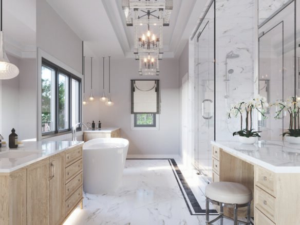 Discover a luxurious bathroom in one of the new homes featuring a freestanding bathtub, marble flooring, and countertops. Enjoy a spacious glass-enclosed shower, dual vanities with wooden cabinetry, and elegant pendant lighting complemented by orchids placed on the counter.